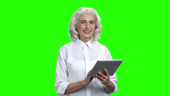 Elegant Senior Woman Holding Digital Tablet