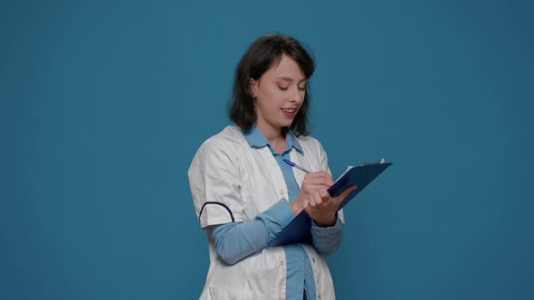 Female Scientist Taking Notes on Clipboard Documents