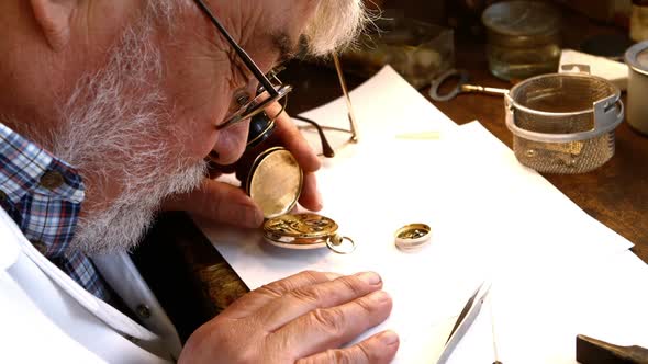 Horologist repairing a pocket watch