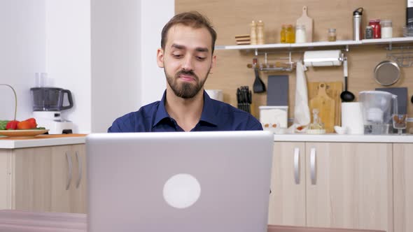 Young Man Working at the Laptop Computer