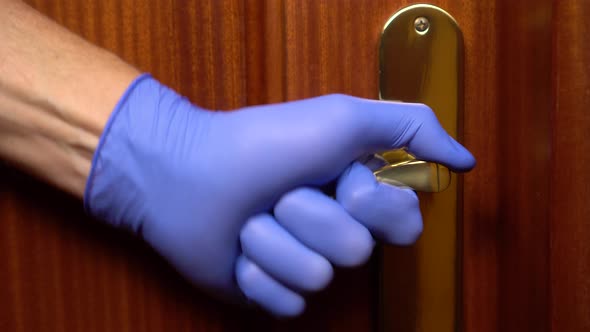 Coronavirus outbreak. A man in medical gloves opens the door