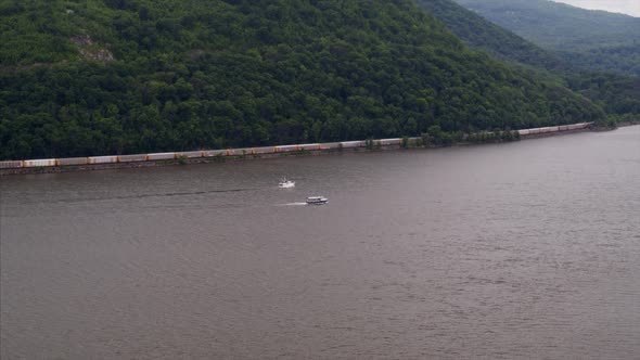 Aerial of Train Passing by the Hudson River