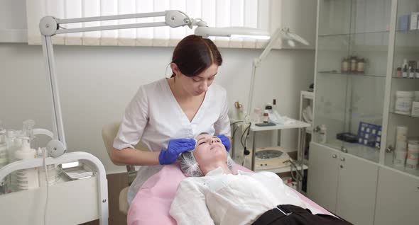 Cleaning the Skin of Beautiful Woman with a Sponge