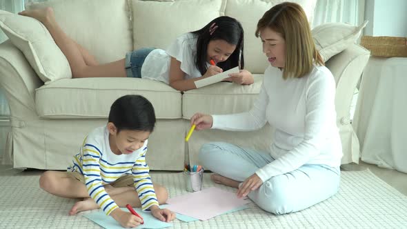 Asian Family Drawing Together In Living Room