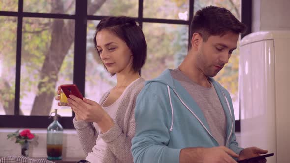Girlfriend and Boyfriend Use Gadgets in Flat