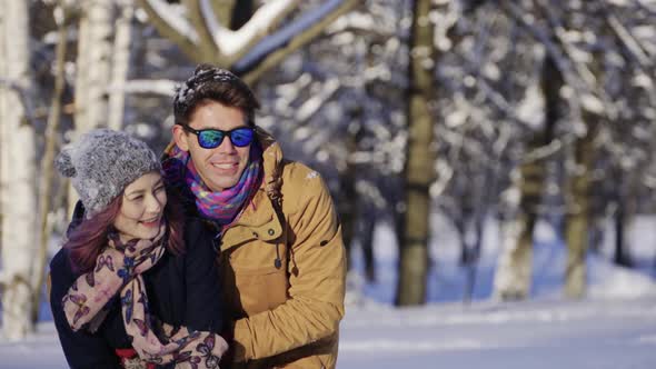 Young Happy Multicultural Couple Waving Hand to Somebody Winter