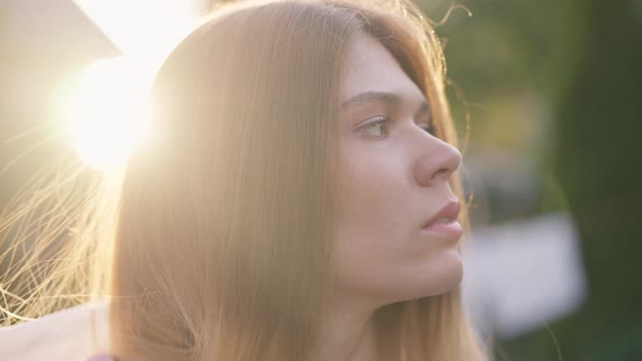 Headshot Young Gorgeous Caucasian Woman Posing in Sunrays with White Scarf in Slow Motion