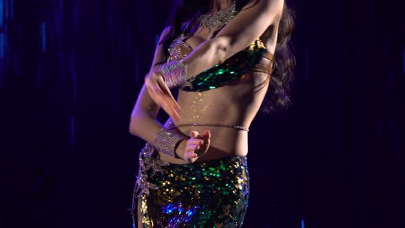 Young Woman in an Exotic Green Suit Performs Belly Dance Moves Hips and Wriggle Half Naked Body