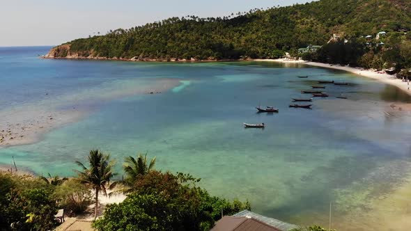 Boats Near Shore of Island. Traditional Colorful Fishing Vessels Floating on Calm Blue Water Near