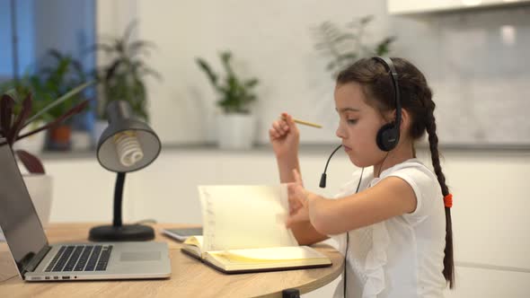 Little Girl Kid Studen Studying Online Class with Laptop at Home New Normal