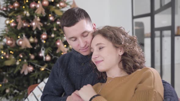 Close-up of Loving Beautiful Woman Putting Head on Man's Shoulder and Smiling. Portrait of Happy