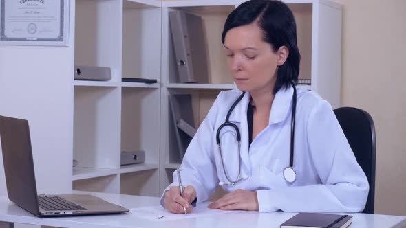 Doctor Sitting at the Workplace in Office