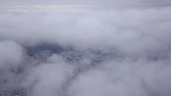 Top view through the clouds on the city of Almaty