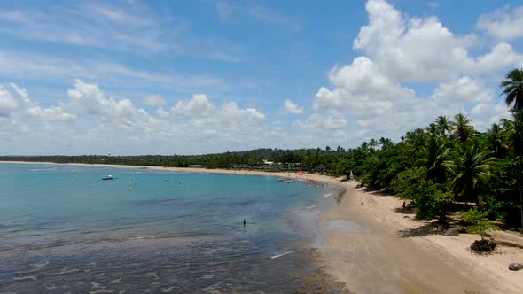 Aerial View of Tropical White Sand Beach, Palm Trees and Turquoise Clear Sea Water in Praia Do Forte