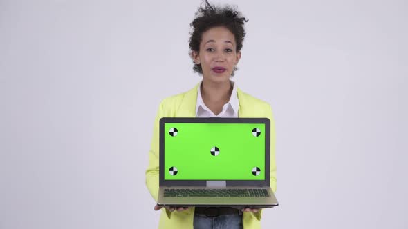 Happy Young African Businesswoman Showing Laptop and Looking Surprised