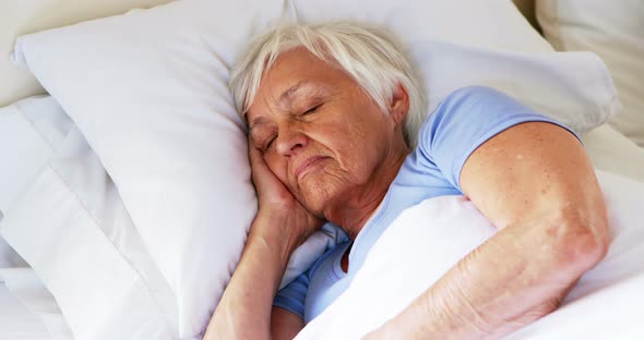 Senior woman sleeping in the bedroom