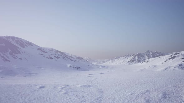 Aerial Landscape of Snowy Mountains and Icy Shores in Antarctica