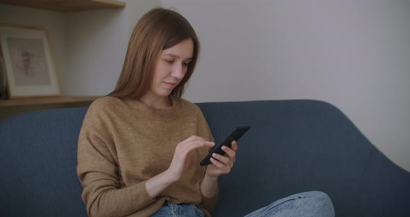 Business Woman Typing Message on Mobile Phone at Home Office. Young Girl Chatting on Phone in Slow