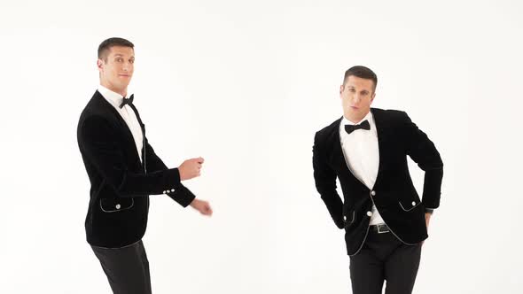 Two fun Men in Black Suits are Dancing