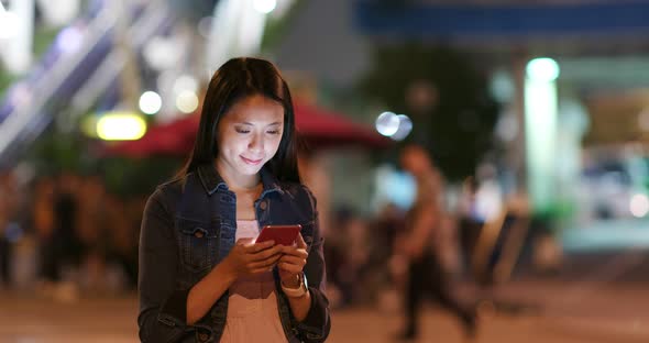 Woman use of mobile phone in city