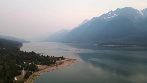 Beautiful landscapes of Kinbasket Lake and the Rocky Mountains during wildfires near Canoe Reach in