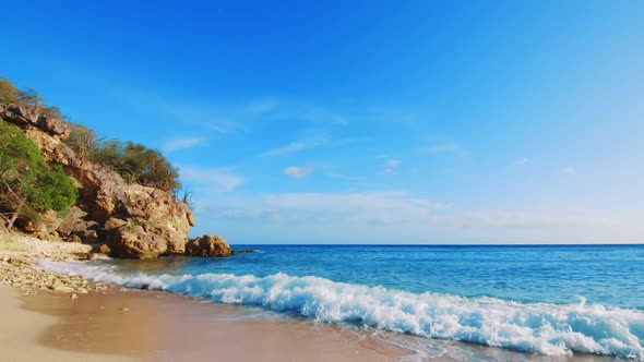 Static camera filming a landscape of a beach with waves in Curacao