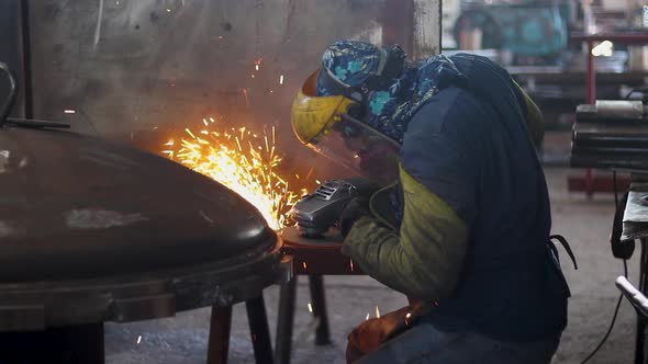 Worker polishing in metal industry