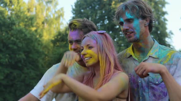 Smiling Friends Colored With Powder Paint Having Fun and Posing for Camera