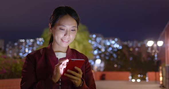 Woman use of mobile phone at night