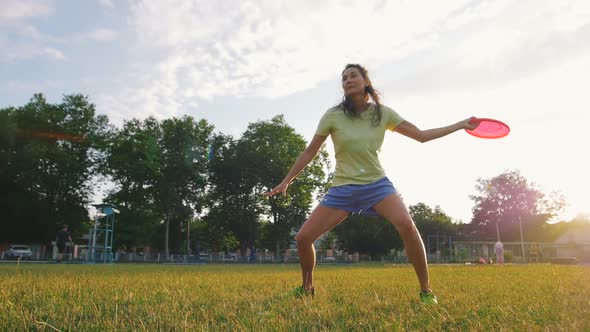 Young and Beautiful Woman Playing Frisbee in the Park Slow Motion