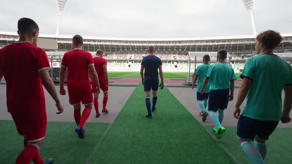 Professional Football Players Walks to the Stadium Rival Football Teams Walk Through the Stadium