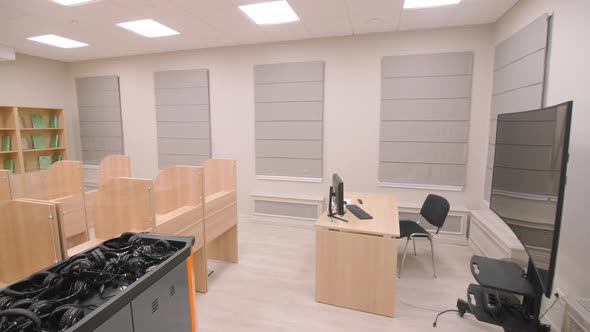 Separated Desks and Container with Headphones in IT Class