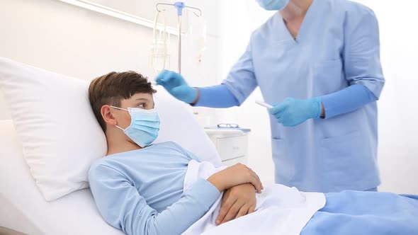 child in the hospital bed, nurse with thermometer measures temperature of the fever