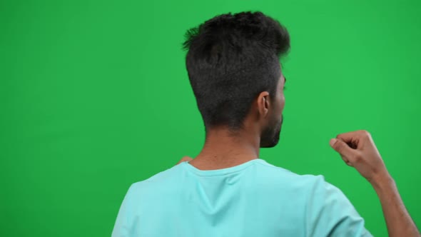 Back View Motivated Middle Eastern Man Gesturing Cheering for Football Team on Green Screen