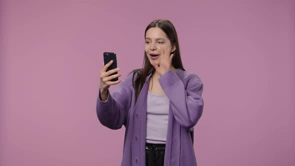 Portrait of a Model with Natural Beauty is Talking on a Video Call Using a Smartphone