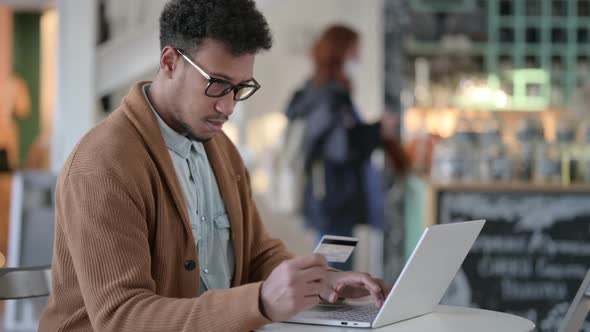 Successful Online Shopping on Laptop By African Man