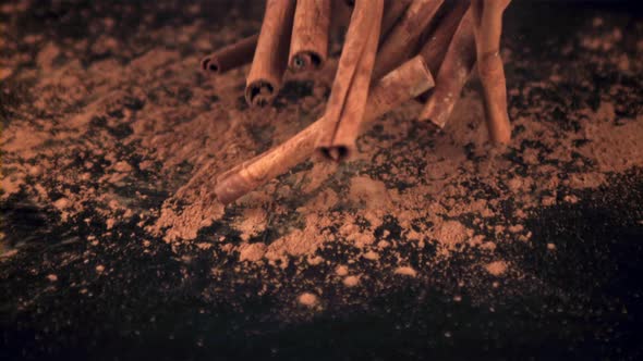 Super Slow Motion on the Table with Powder Falling Off a Bunch of Cinnamon Sticks