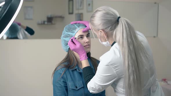 Girl Undergoes Eyebrows Tattooing with Master Slow Motion