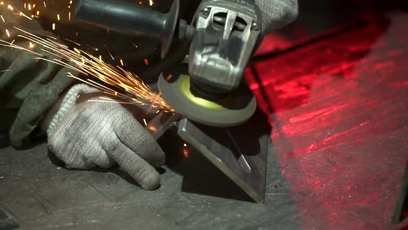 Hand man work wearing gloves while Grinding metal