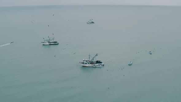 Aerial footage, flying towards relative small fishing boats 