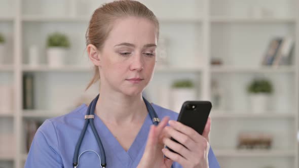 Attractive Young Female Doctor Using Smartphone