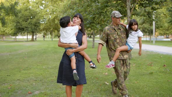 Happy Military Man Walking in Park with His Family