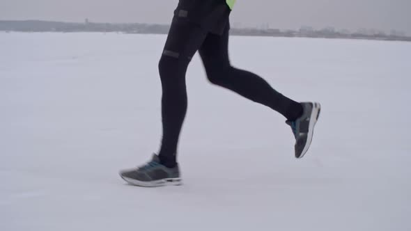 Athlete Running in Snow-covered Countryside