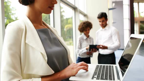 Female executive using laptop