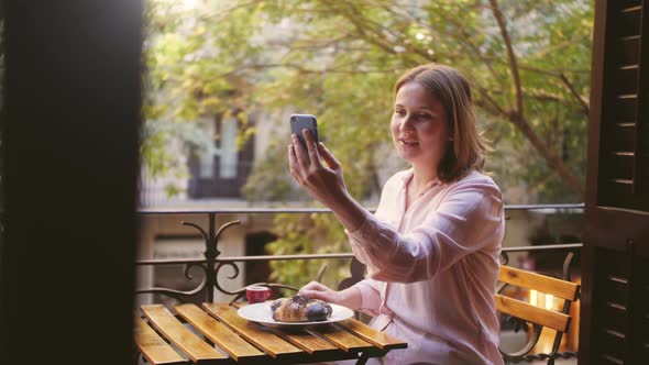 Happy Young Woman Making Facetime Video Chat Calling with Smartphone at Home in Balcony During