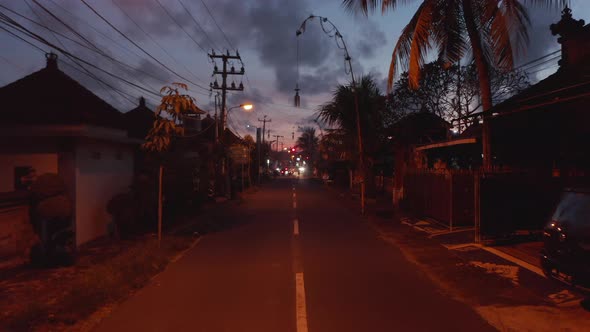 Motorcycles Driving on a Dark Street in Bali Indonesia