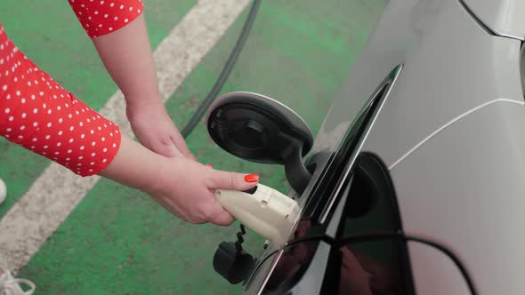 Female Hands Unplugs Cable