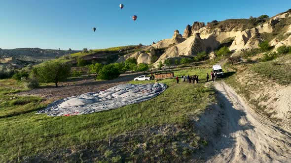 4K Aerial view of Goreme. Colorful hot air balloons fly over the valleys.