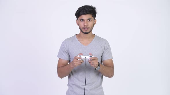 Young Stressed Bearded Indian Man Playing Games and Losing