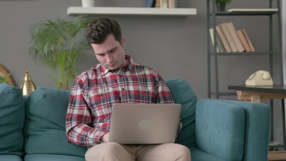 Man with Laptop Taking Nap on Sofa